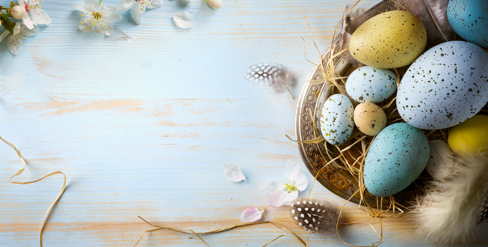 Easter background with Easter eggs on blue table